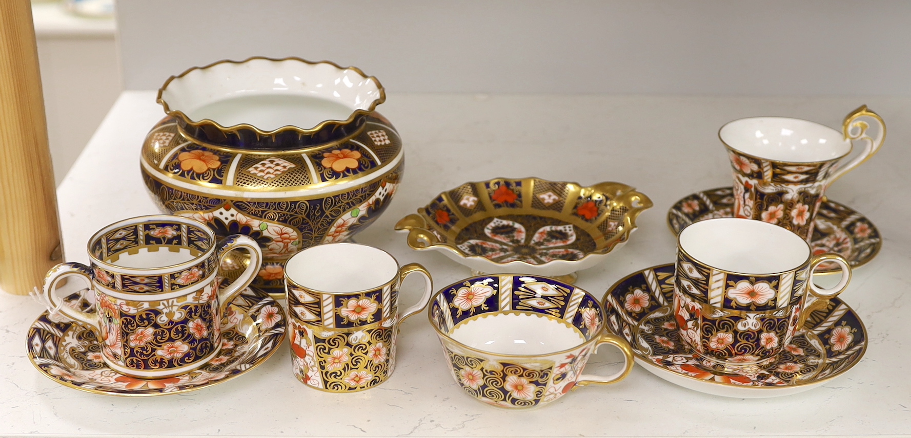 A Royal Crown Derby spherical vase with pie crust rim painted with pattern 1128, a two handled dish in the same pattern, five cups and three saucers in pattern 2451